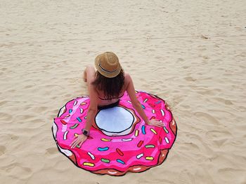 Rear view of woman wearing hat on beach