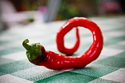 Close-up of red chili pepper on table