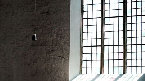 Pendant light hanging against wall