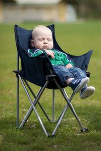 Cute girl sitting on seat in field