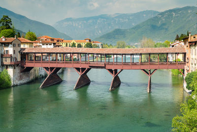 Bridge over river against mountains