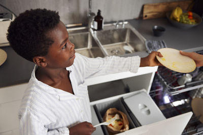 Mother and son washing dishes