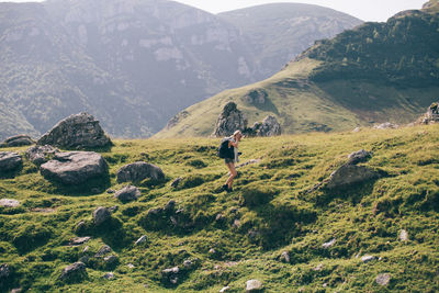 Hiker with camera walking on mountain