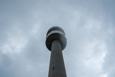 Low angle view of communications tower against sky