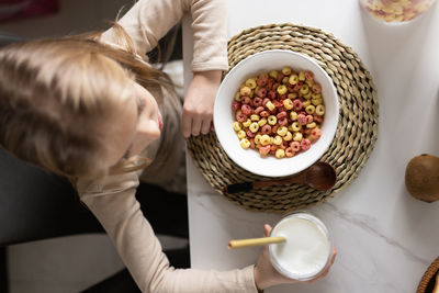 Midsection of woman holding food on table