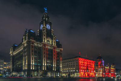 Low angle view of illuminated building against sky at night