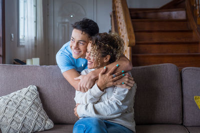 Happy couple sitting on sofa