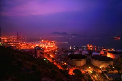 Aerial view of city lit up at night