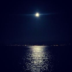 Scenic view of lake against sky at night