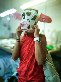 Portrait of person wearing cow mask