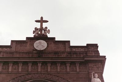 Low angle view of clock tower against sky