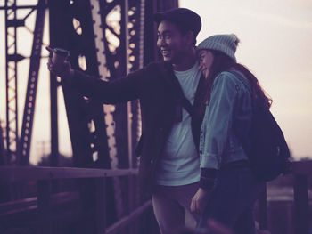 Couple standing on bridge