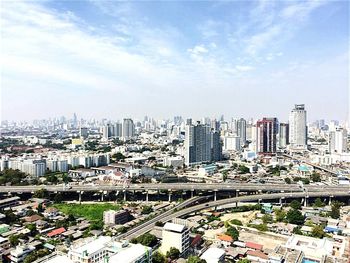 Cityscape against cloudy sky