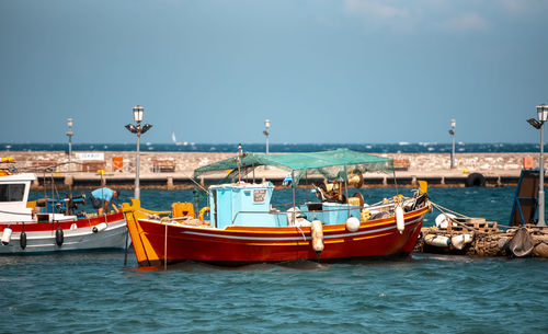 Boats in sea against sky mykonos greece