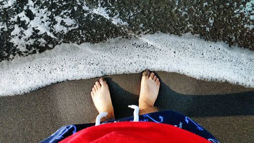 Low section of legs on sand at beach