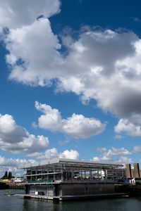 Bridge over river against buildings in city