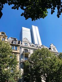 Low angle view of buildings against clear blue sky