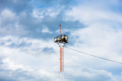 Low angle view of communications tower against sky