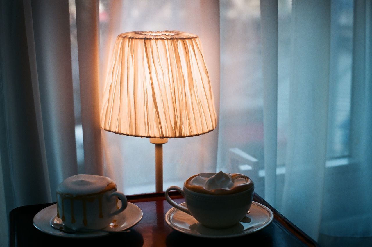 CLOSE-UP OF COFFEE CUP ON TABLE WITH SPOON