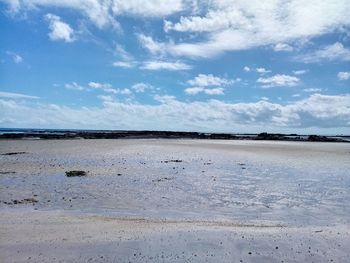 Scenic view of beach against blue sky