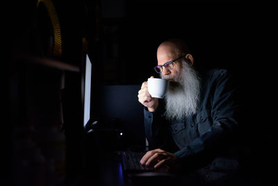 Man drinking coffee while sitting at home