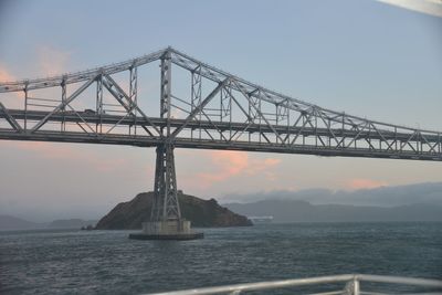 Low angle view of suspension bridge against sky