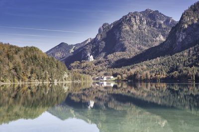 Scenic view of lake and mountains in direction of castle neuschwanstein 