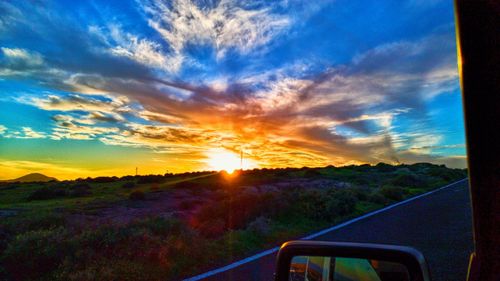 Scenic view of field against sky during sunset