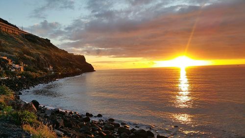 Scenic view of calm sea at sunset