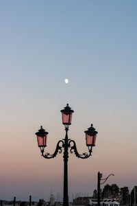 Low angle view of street light against sky at sunset