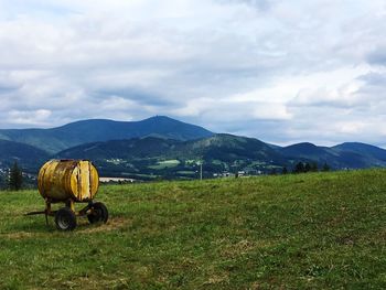 Hay bales on field against sky