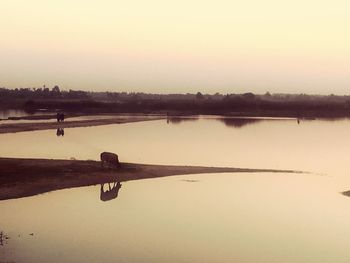 Scenic view of lake against sky during sunset