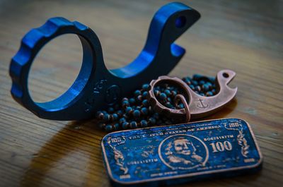 Close-up of key ring and necklace on table