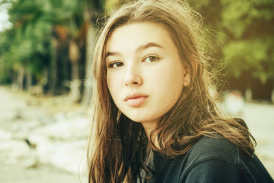 Pensive teenage girl in nature close-up face