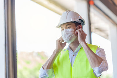 Worker wearing hardhat and mask