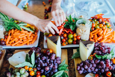 Cropped image of person at raw food in tray on table