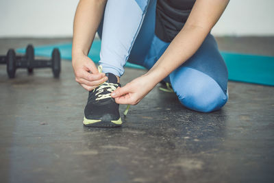 Low section of woman lying on floor
