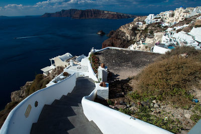 High angle view of buildings by sea at oia