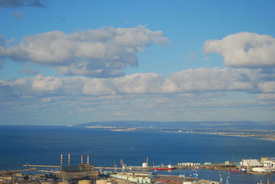 View of cityscape against cloudy sky