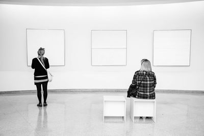 Rear view of woman standing in museum