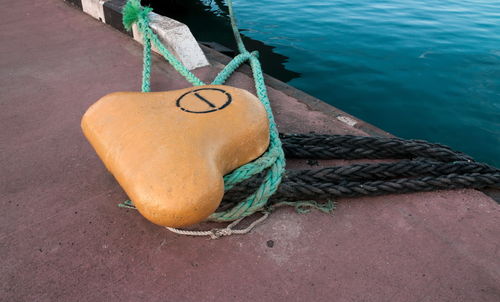 High angle view of rope tied to bollard on pier