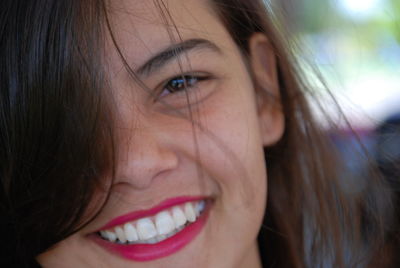 Close-up portrait of smiling young woman