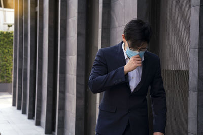 Man standing in front of office building