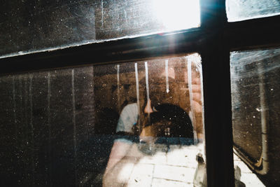 Close-up of hand on window