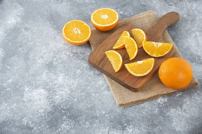 High angle view of orange fruits on cutting board