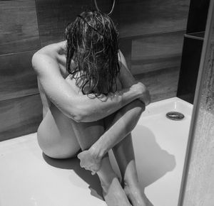 Naked woman bathing in bathroom