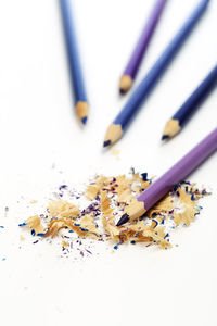 High angle view of colored pencils on white table