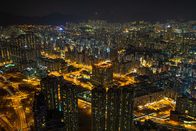 High angle view of illuminated modern buildings in city at night