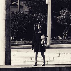 Full length portrait of young woman with cat