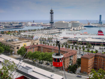 Tower amidst buildings at harbor on sunny day